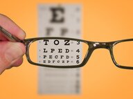 Picture of a pair of glasses looking at an eye chart